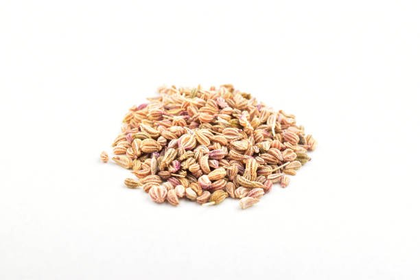 Closuep of carom seeds on white background